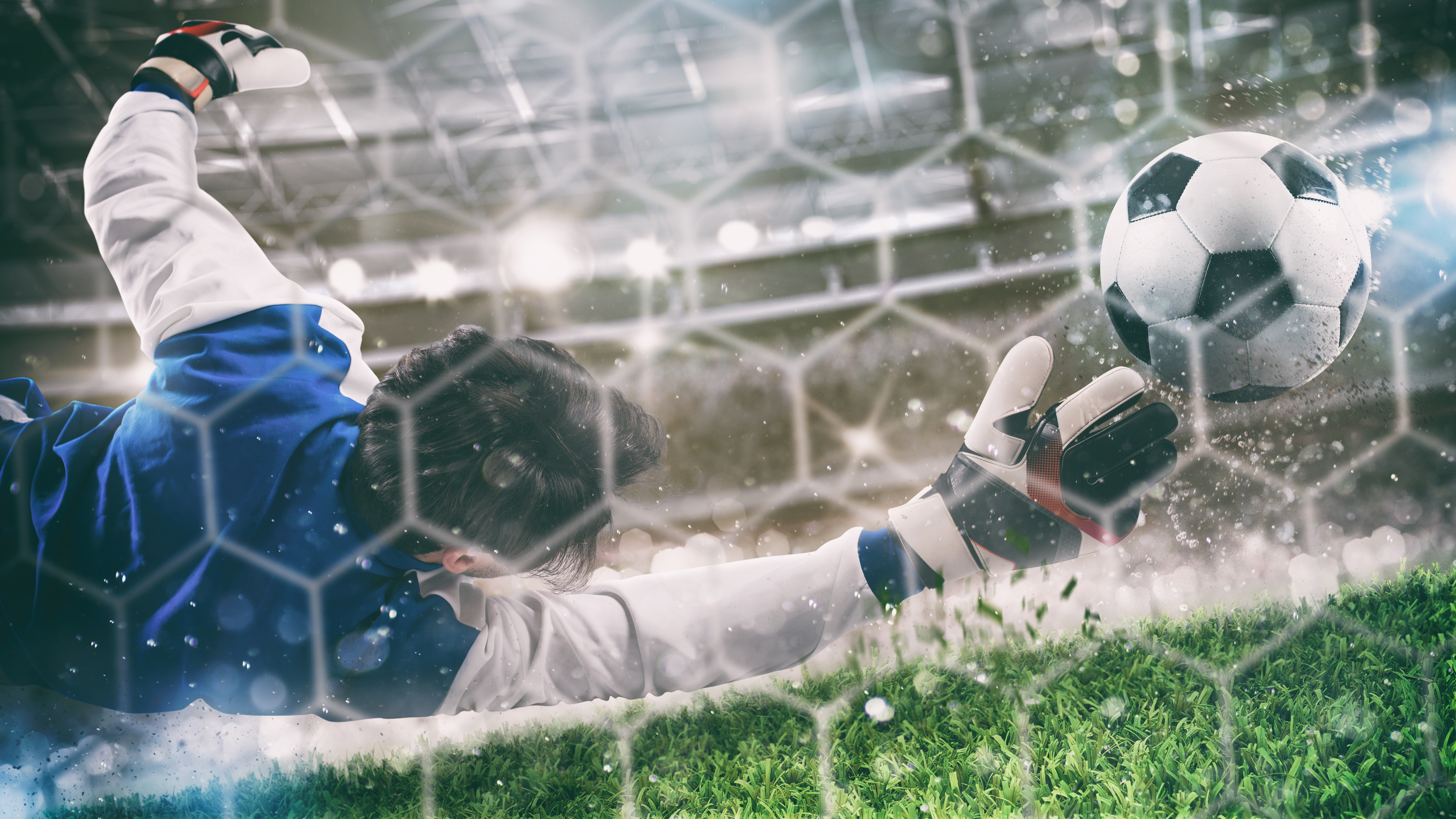 Goalkeeper catching the ball during a stadium football match