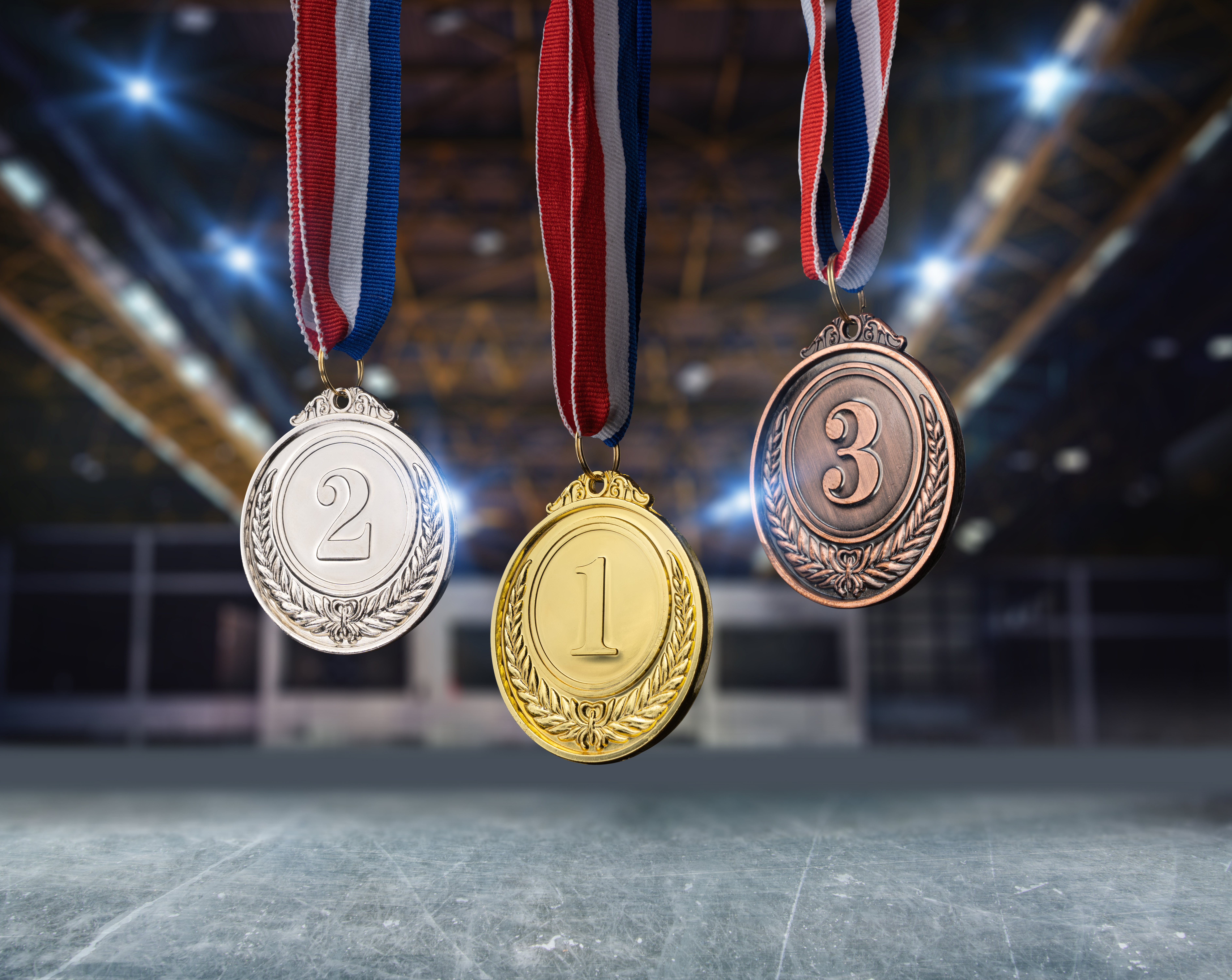 Gold, silver, and bronze medals hanging on ribbons