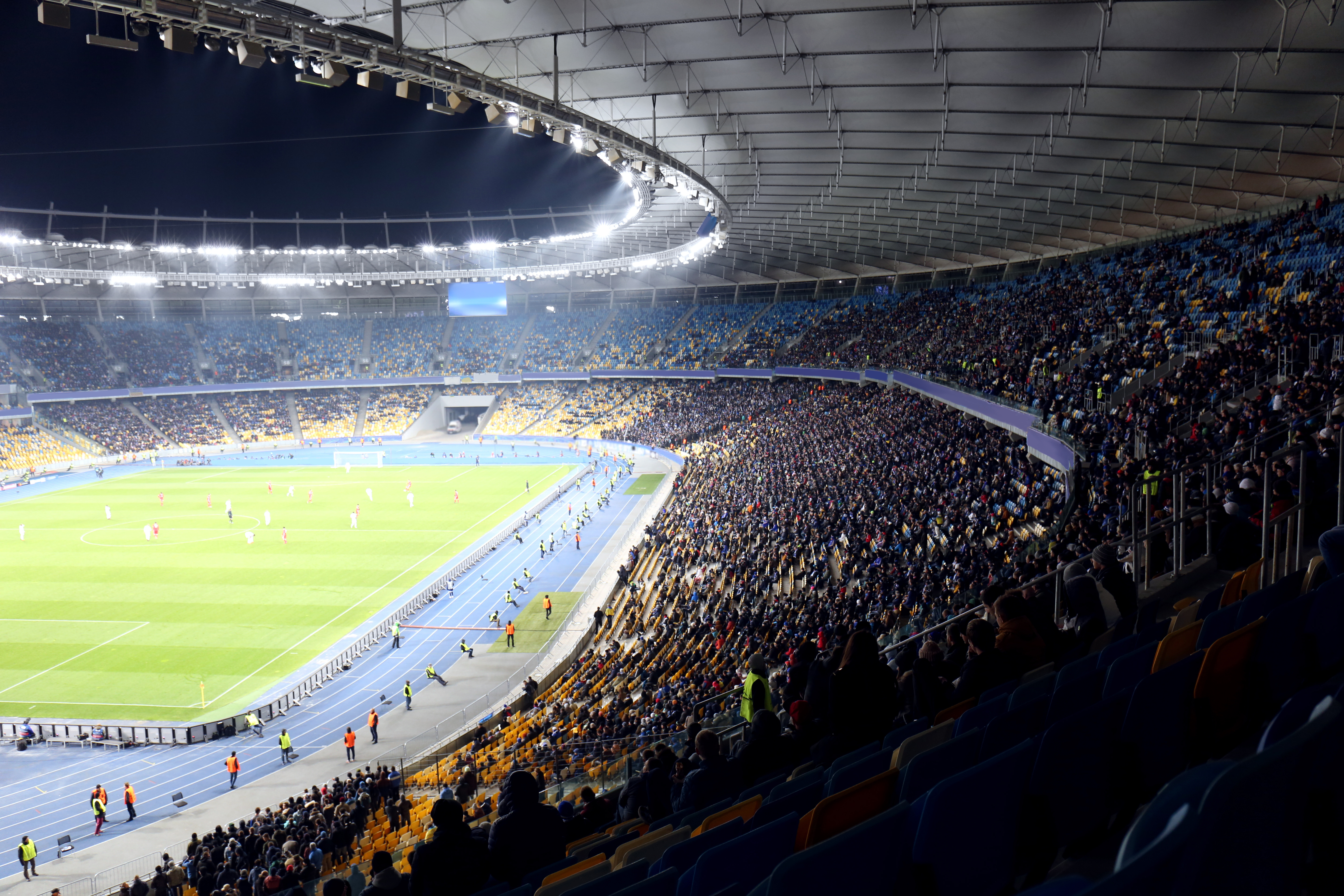 Panoramic view of a full modern football stadium bowl during a match, illustrating the scale expected at MetLife Stadium